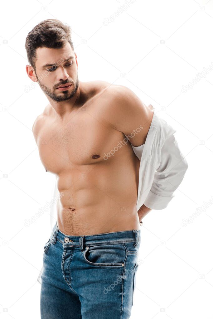 brunette muscular man in white shirt and jeans isolated on white
