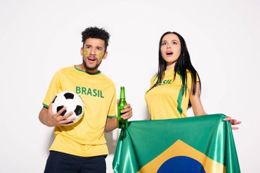 Brezilya bayrağı, top ve bira şişesini gri renkte tutan çok kültürlü taraftarlar.
