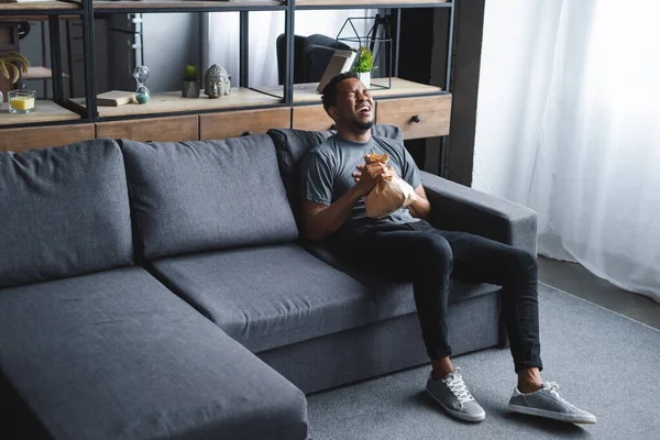 Worried African American Man Holding Paper Bag While Having Panic — Stock Photo, Image