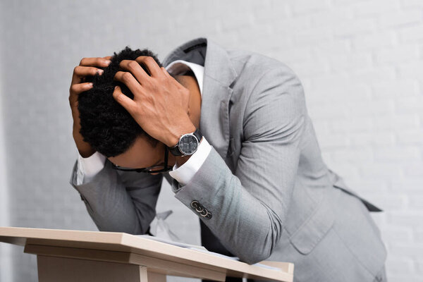 exhausted african american speaker on business conference in office