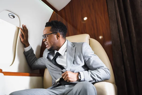 Besorgter Afrikanisch Amerikanischer Geschäftsmann Mit Sicherheitsgurt Und Panikattacke Während Flug — Stockfoto