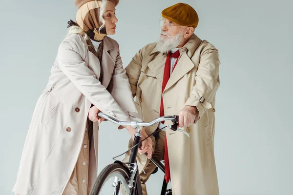 Elegant Senior Couple Looking Each Other Bicycle Isolated Grey — Stock Photo, Image