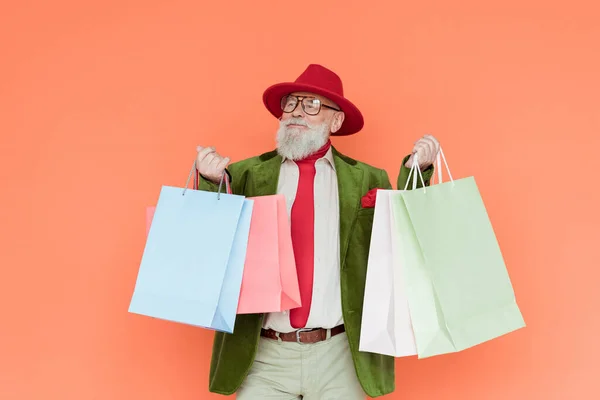 Fashionable Elderly Man Holding Shopping Bags Isolated Coral — Stock Photo, Image