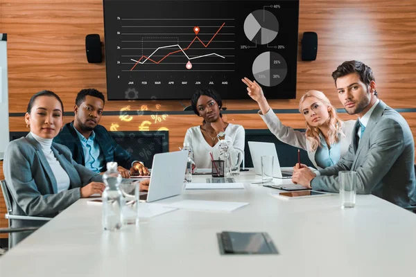 Young Businesswoman Raising Hand While Sitting Conference Hall Charts Graphs — Stock Photo, Image