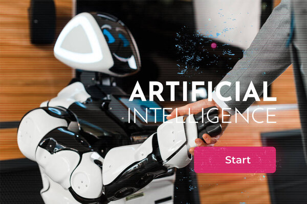 cropped view of businessman shaking hands with smiling robot in office, Artificial Intelligence illustration