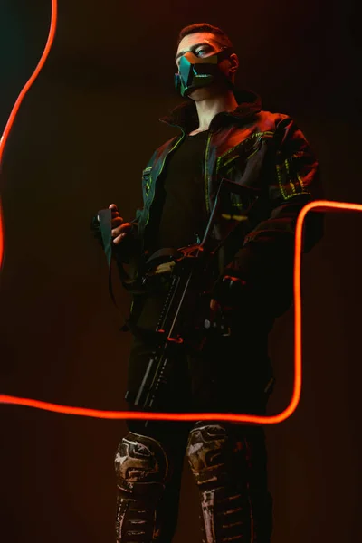 Dangerous Racial Cyberpunk Player Protective Mask Holding Gun Neon Lighting — Stock Photo, Image