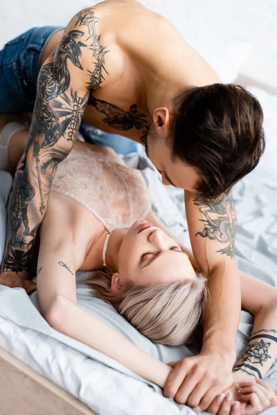 Shirtless Tattooed Man Touching Hand Beautiful Girlfriend Underwear Bed White — Stock Photo, Image