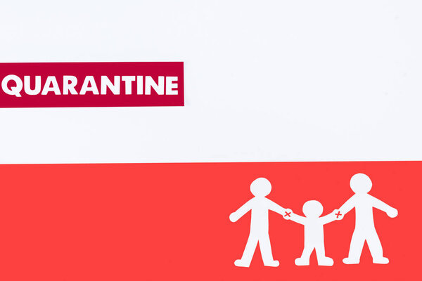 top view of quarantine lettering near paper people on polish flag