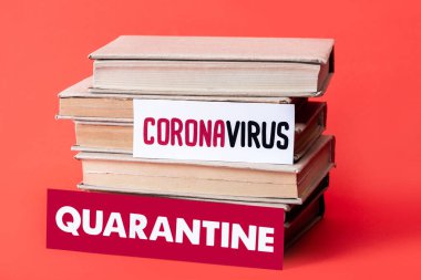 books near cards with quarantine and coronavirus lettering on red with copy space clipart