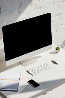 home office with computer and smartphone with blank screens clipart