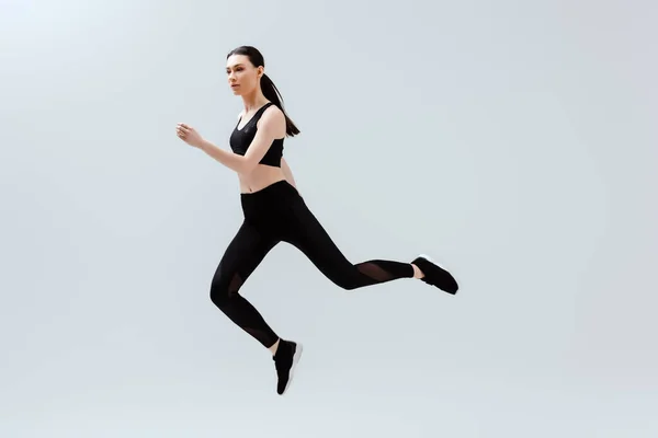 Pretty Woman Black Sportswear Jumping Isolated White — Stock Photo, Image