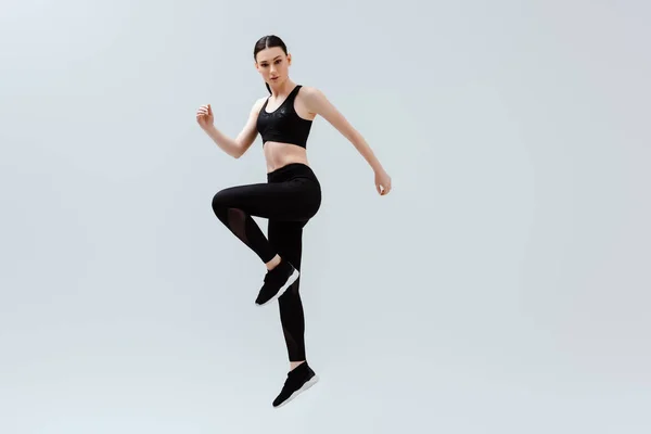 Sportive Woman Black Sportswear Jumping Isolated White — Stock Photo, Image