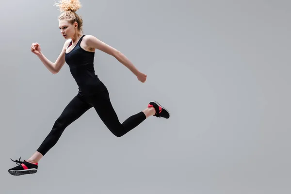 Young Curly Sportswoman Sportswear Jumping Isolated Grey — Stock Photo, Image