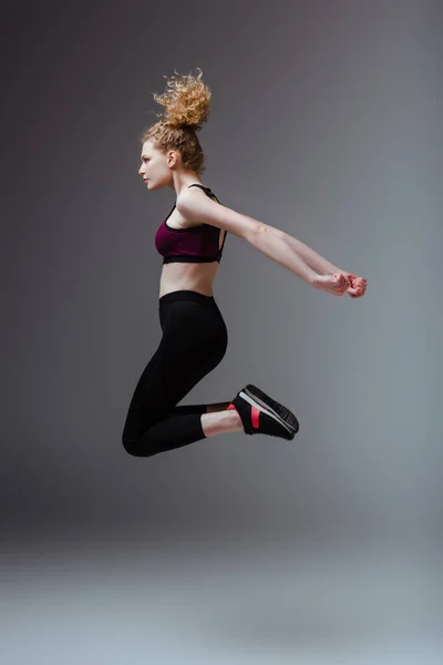 Side View Curly Woman Sportswear Jumping Grey — Stock Photo, Image