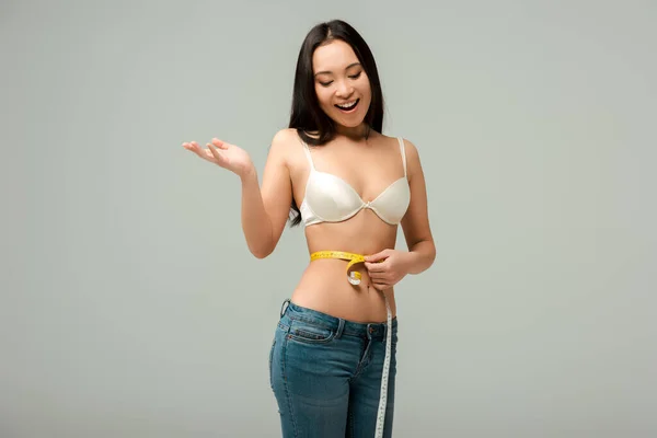 Cheerful Overweight Asian Girl Measuring Waist Isolated Grey — Stock Photo, Image