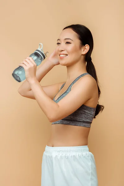 Deportiva Asiática Sonriendo Con Botella Deportiva Aislada Beige — Foto de Stock