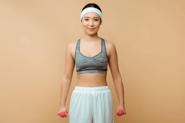 Asian Sportswoman Dumbbells Smiling Looking Camera Isolated Beige — Stock Photo, Image