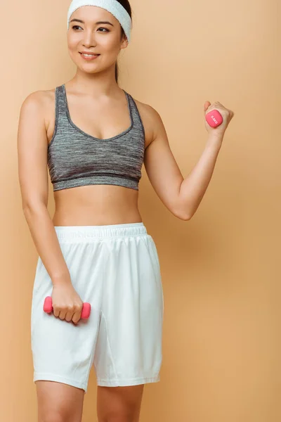 Asian Sportswoman Looking Away Smiling Training Dumbbells Beige — Stock Photo, Image