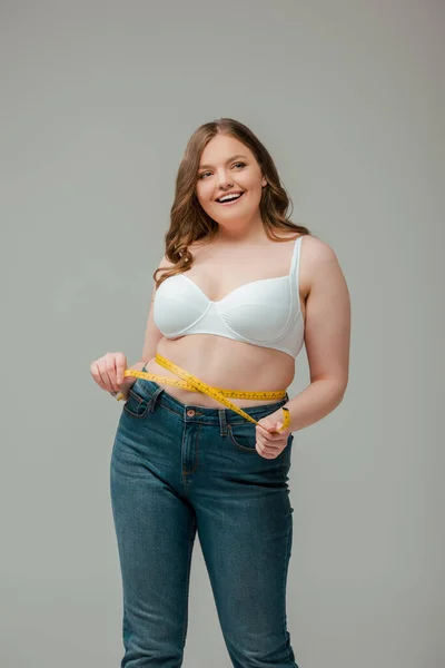 Size Woman Measuring Waist Looking Away Smiling Isolated Grey — Stock Photo, Image
