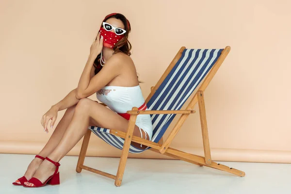 Stylish Girl Sunglasses Mask Swimsuit Sitting Deck Chair Beige — Stock Photo, Image