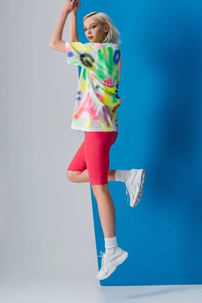 Attractive Girl Jumping Neon Pink Bike Shorts Colorful Shirt Grey — Stock Photo, Image