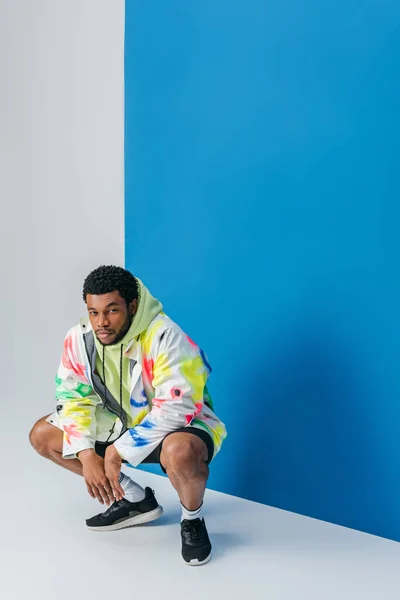 Snygg Ung Afrikansk Amerikansk Man Poserar Färgglada Futuristiska Kläder Grå — Stockfoto