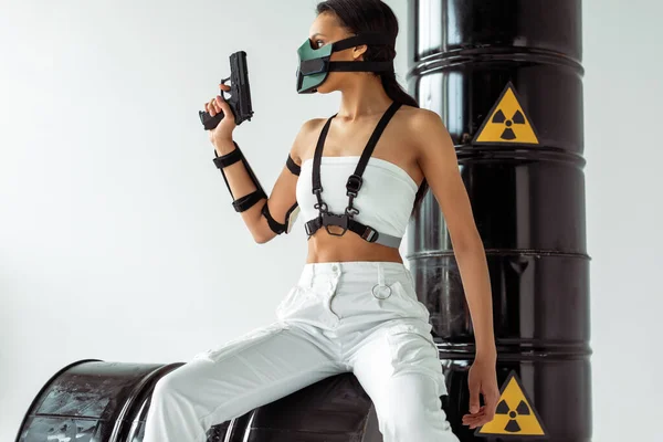 Futuristic African American Woman Safety Mask Gun Radioactive Waste Barrels — Stock Photo, Image