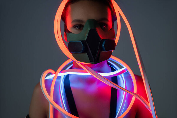 futuristic african american woman in respirator and neon lighting