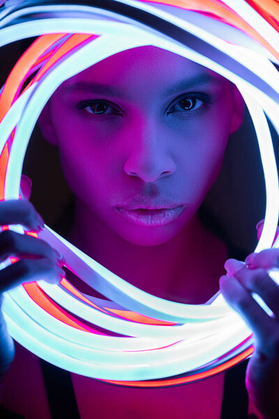 portrait of futuristic african american woman in neon lighting