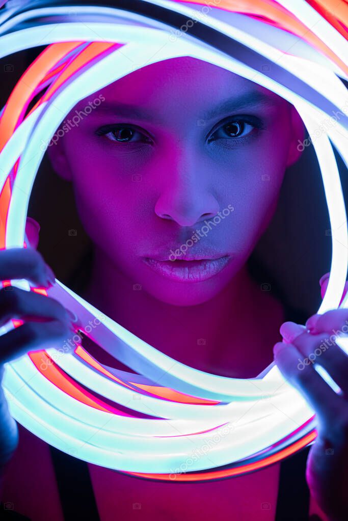 portrait of futuristic african american woman in neon lighting