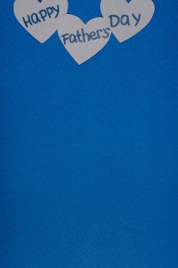 top view of grey paper crafted hearts with lettering happy fathers day on blue background clipart