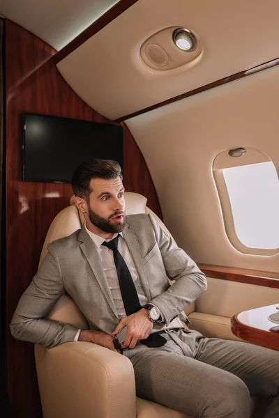 Scared Businessman Fastening Safety Belt While Looking Porthole Private Plane — Stock Photo, Image