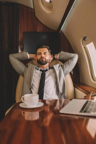 Young Businessman Resting Hands Head Closed Eyes Private Jet — Stock Photo, Image