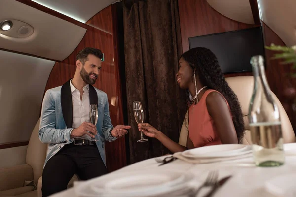 Selective Focus Smiling Interracial Couple Clinking Glasses Champagne Private Jet — Stock Photo, Image