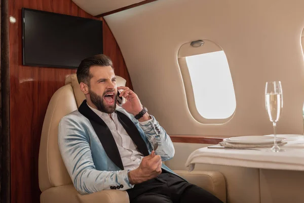 Hombre Enojado Gritando Mientras Habla Teléfono Inteligente Avión Privado — Foto de Stock