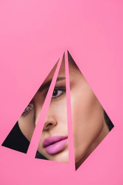 Woman with pink lips looking across triangular holes in paper clipart