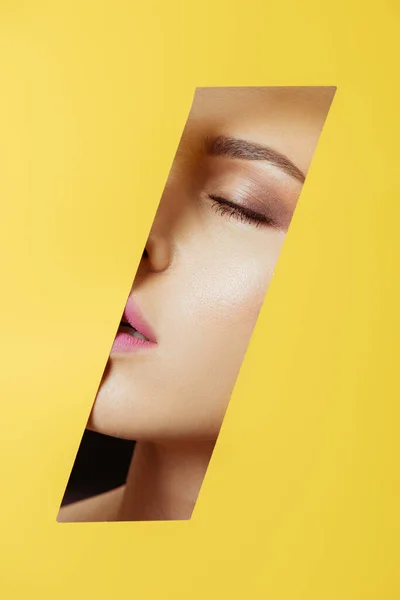 Female Face Closed Eyes Hole Yellow Paper — Stock Photo, Image