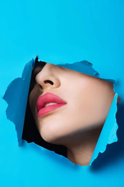 Female Face Pink Lips Hole Bright Blue Paper — Stock Photo, Image