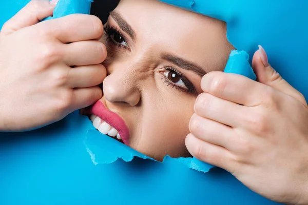Woman Pink Lips Smoky Eyes Touching Biting Ripped Blue Paper — Stock Photo, Image