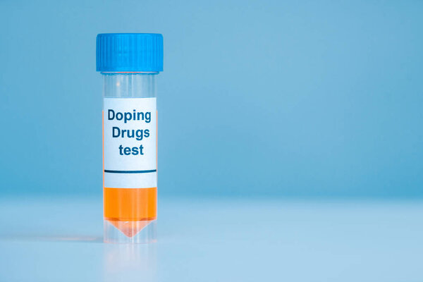 container with urine sample and doping drugs test lettering on blue 