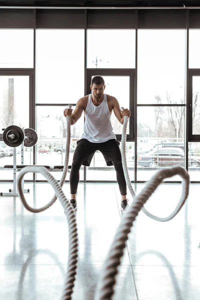 Selective Focus Concentrated Sportsman Exercising Battle Ropes Modern Gym — Stock Photo, Image
