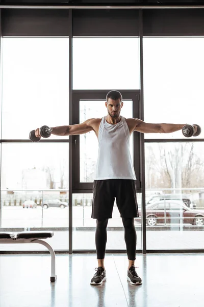 Athletic Man Outstretched Hands Working Out Dumbbells Gym — Stock Photo, Image