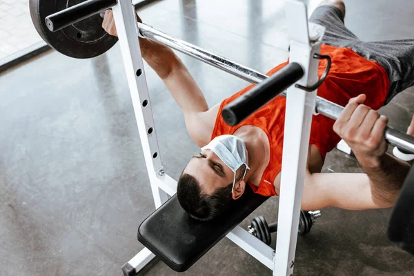 体育館のバーベルで運動する医療面のスポーツマン — ストック写真