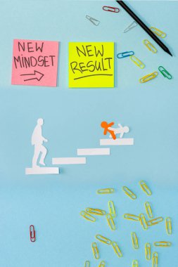 Top view of sticky notes with new mindset and new result lettering with paper clips, pencil and decorative men on career ladder on blue  clipart