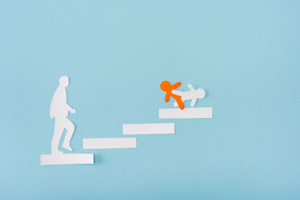 Top view of paper orange and white men on career ladder on blue 