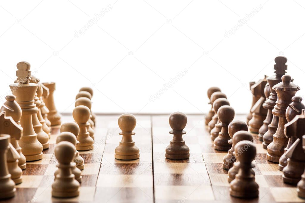 Selective focus of chess pieces and brown pawn against another on chessboard isolated on white