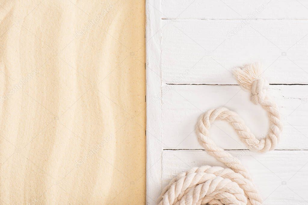 Top view of rope on white wooden planks near sand