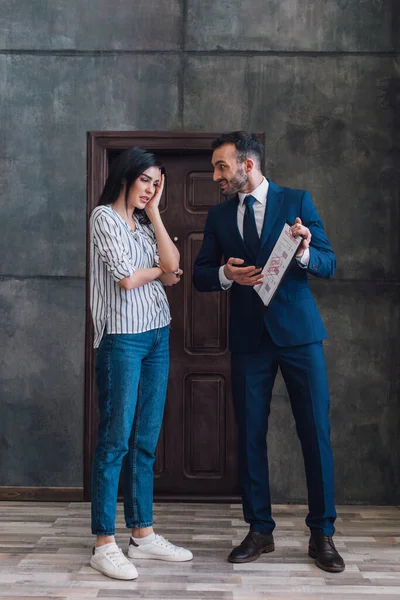 Samlare Pekar Dokument Och Tittar Stressad Kvinna Rummet — Stockfoto