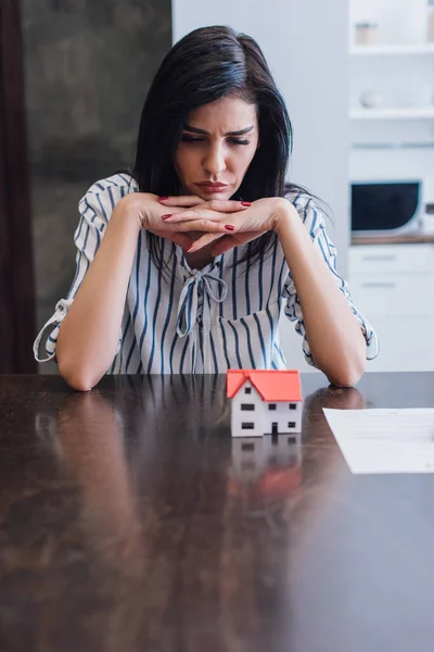 Upset Thoughtful Woman Clenched Hands Table House Model Document Room — Stock Photo, Image