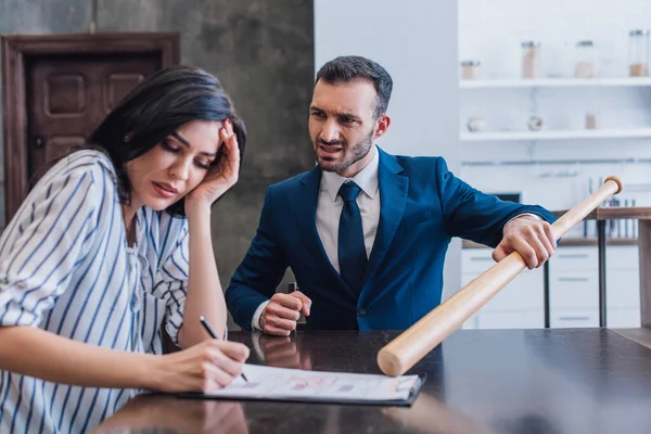 Scared Woman Writing Documents Angry Collector Baseball Bat Table Room — Stock Photo, Image